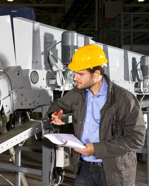 Man Inspecting Machine